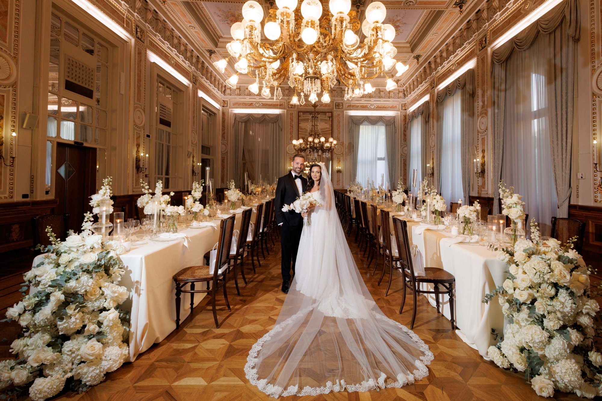 Wedding couple photographed in an ornate ballroom, with the complete photographic composition preserved